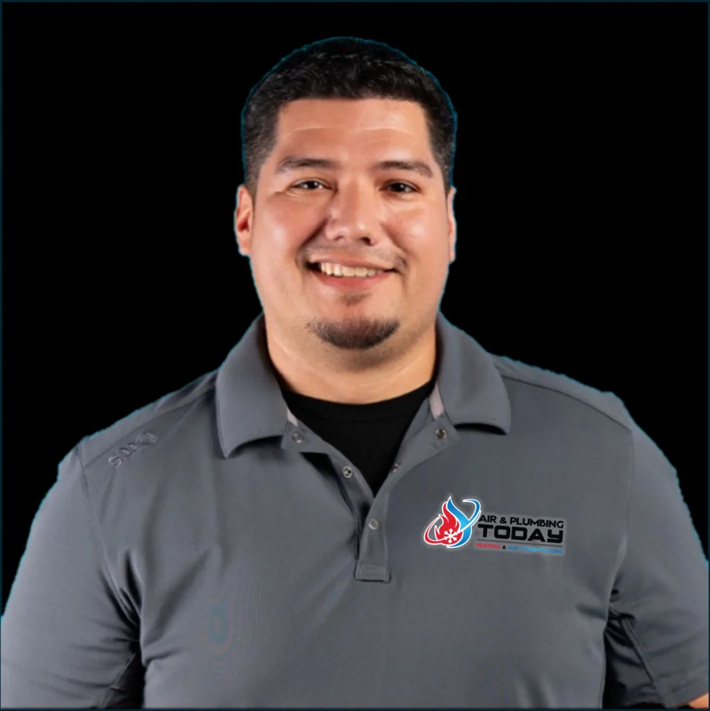 Man wearing a gray "Air & Plumbing Today" polo shirt, smiling and posed against a plain black background, perfect for an about us introduction.